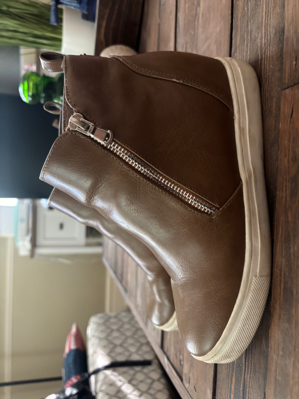 Women’s wedge sneaker with side zippers.